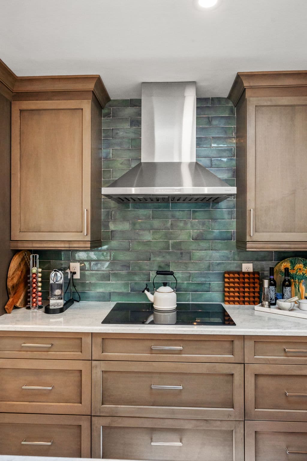 Kitchen remodel with coordinated cabinets, counters, and lighting